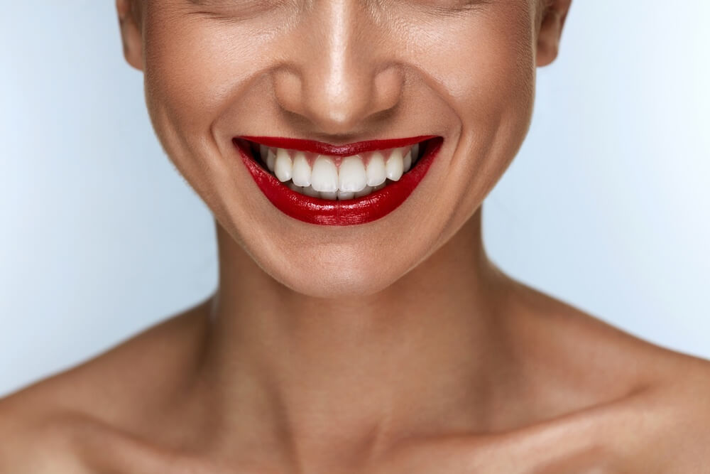 Close up of a woman with red lipstick smiling