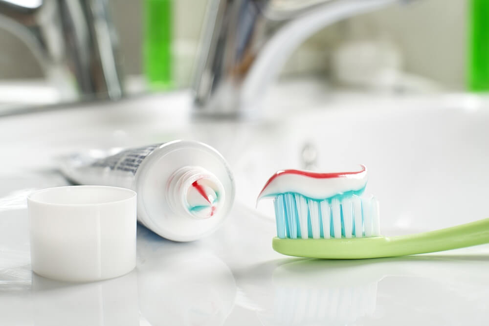 Toothbrush and toothpaste on a bathroom counter