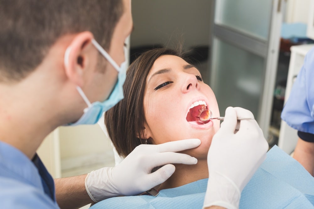 Woman holding her mouth open for dental service